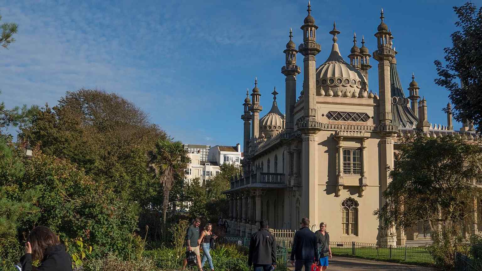 A modern wide exterior that captures the Pavilion as a landmark in the centre of Brighton, far from its original life as a private royal retreat.
