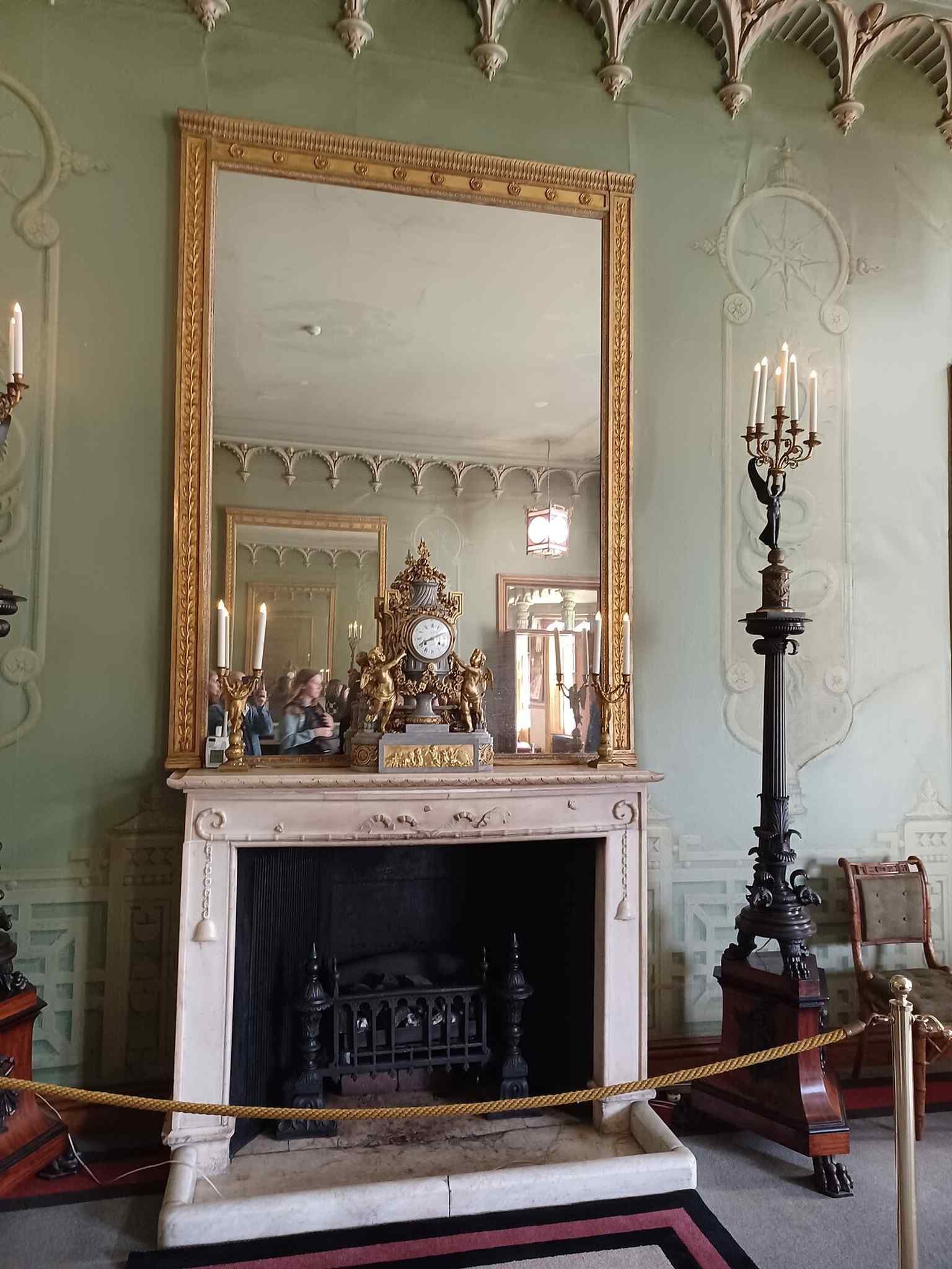 An interior shot with a fireplace, helping show the richly decorated rooms that were later stripped and then painstakingly restored.
