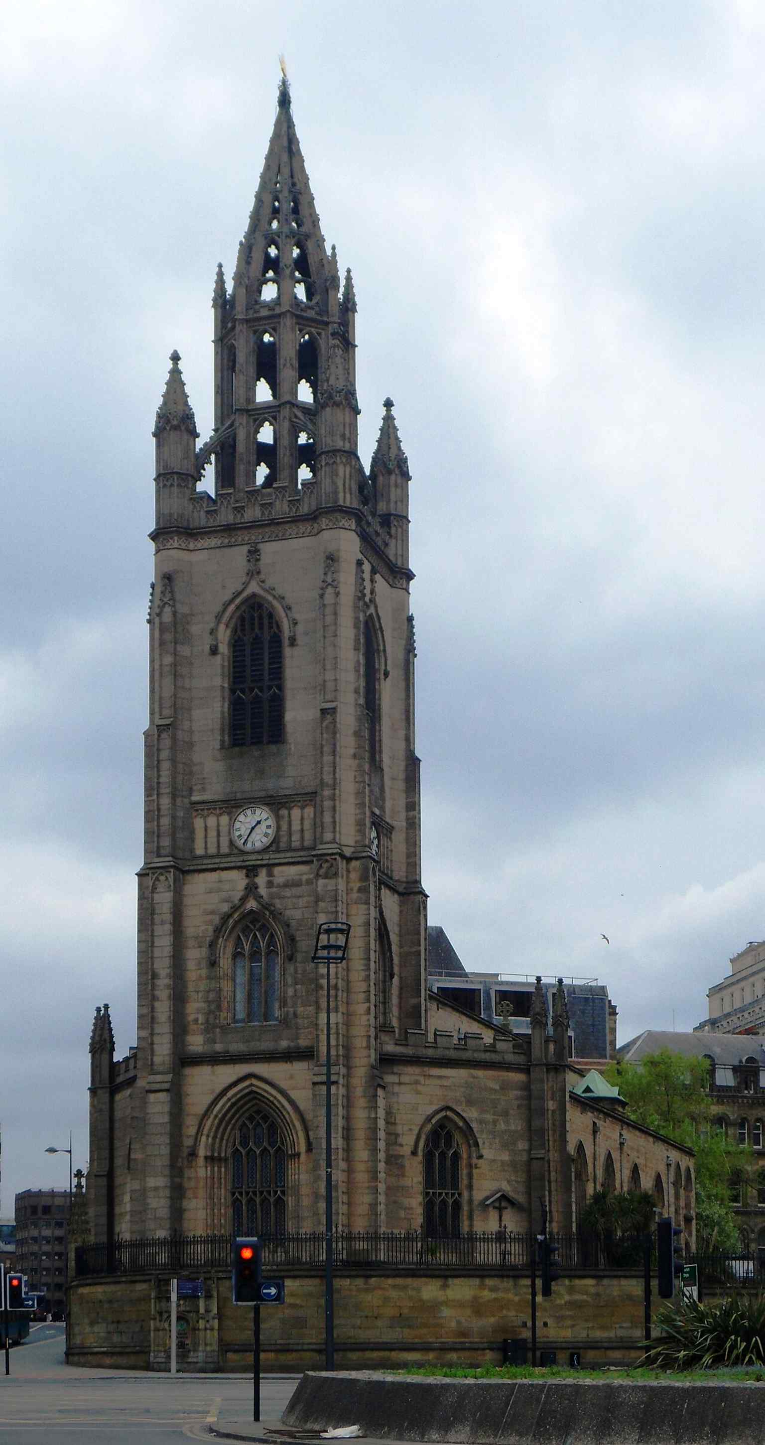 A full-height view of the church on Chapel Street, showing the surviving tower and lantern that once guided shipping on the Mersey.