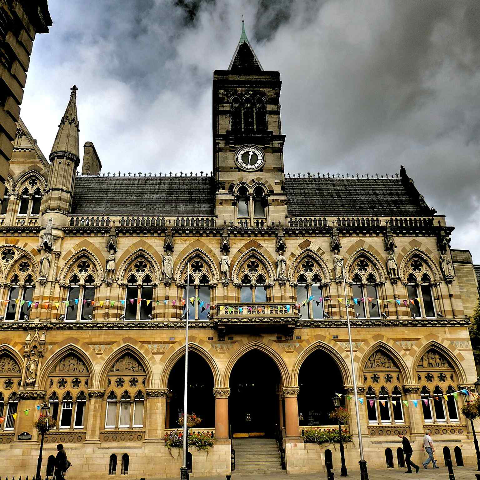 The grand Gothic front of Northampton Guildhall, with its clock tower and arcaded façade added in the 1890s.