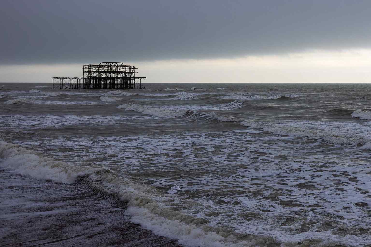 The remains of West Pier in 2024, a stark metal frame left after fire, storms, and partial demolition for the i360 site.