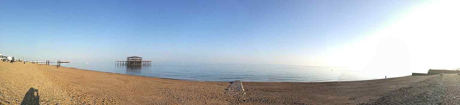 A panoramic seafront view with West Pier ruins stretching into the water, useful for showing the pier’s place on Brighton’s shoreline.
