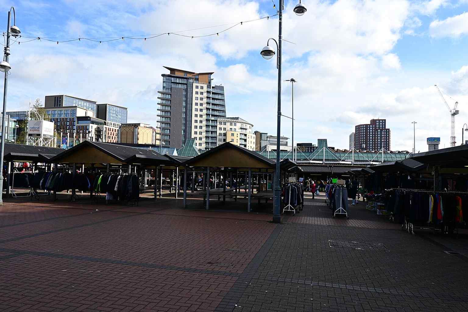 Another exterior view of the outdoor market, showing the modern stalls that sit behind the historic covered halls.