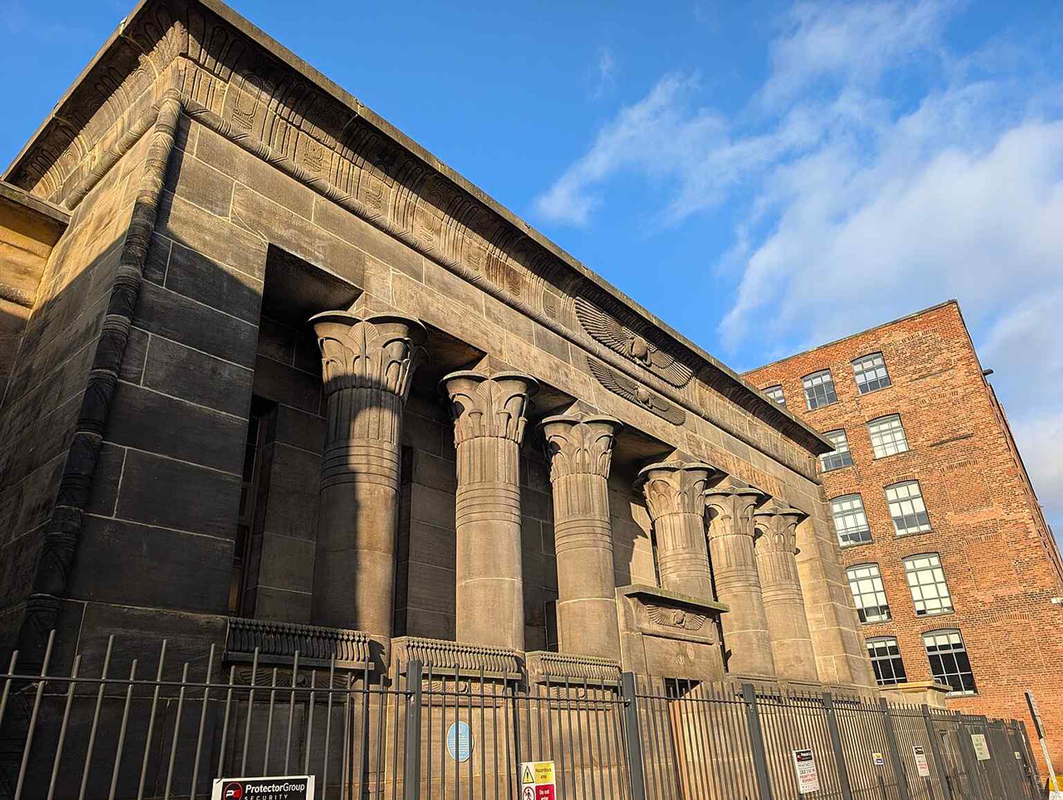 A close exterior detail of Temple Works, useful for its Egyptian-inspired stonework and the distinctive temple-like design linked to Edfu and Dendera.