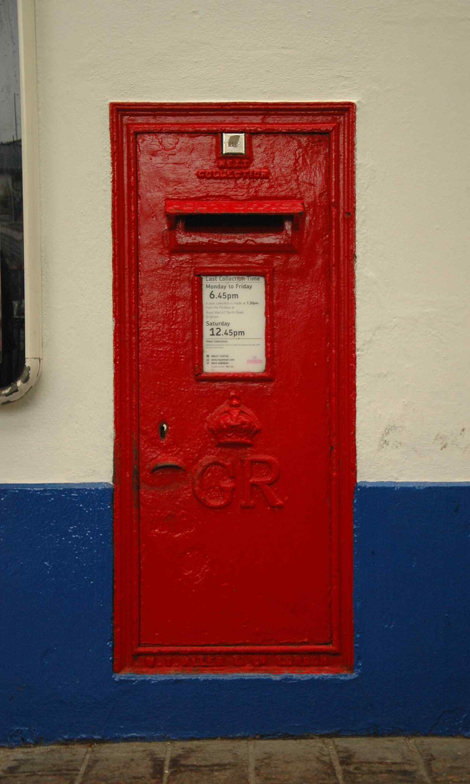 A George V wall-mounted post box inside the station, one of the small everyday features tucked into this busy terminus.