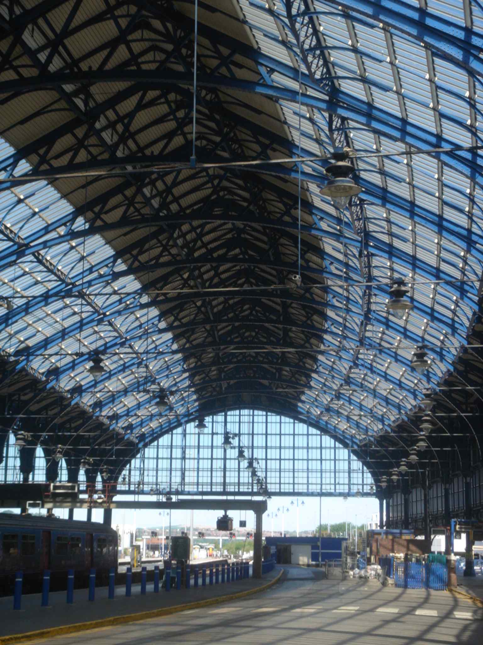 A close-up of the station roof structure, highlighting the iron-and-glass engineering that replaced the earlier separate platform sheds.