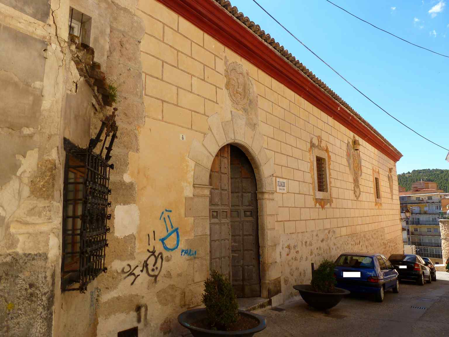 This image captures the facade of The Alhóndiga, a robust municipal building constructed around 1569, which features three prominent shields—two representing Spain and Cuenca, while the third's identity remains a historical mystery.