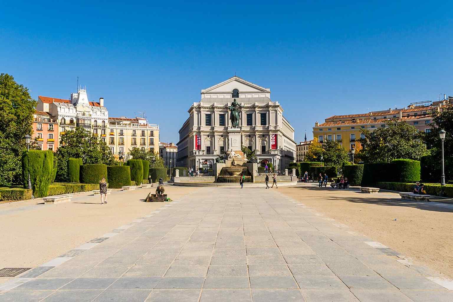 A dramatic telephoto view of the Royal Theatre beside the Royal Palace, echoing its landmark position in central Madrid.