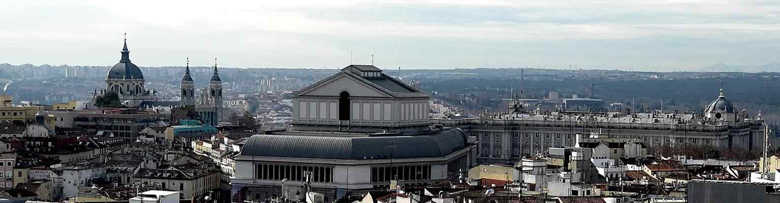 A skyline panorama placing the Royal Palace, the Teatro Real, and the Almudena Cathedral together in one grand Madrid vista.