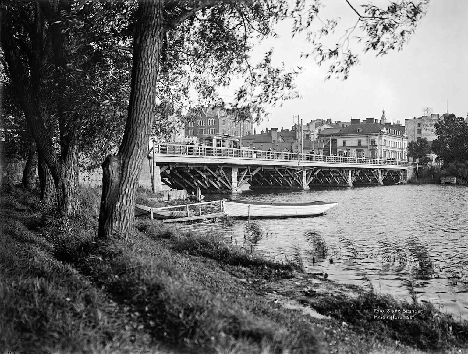 Pitkänsillanranta and the bridge in 1907, with the caption noting the new stone bridge would replace the wooden one in 1912.
