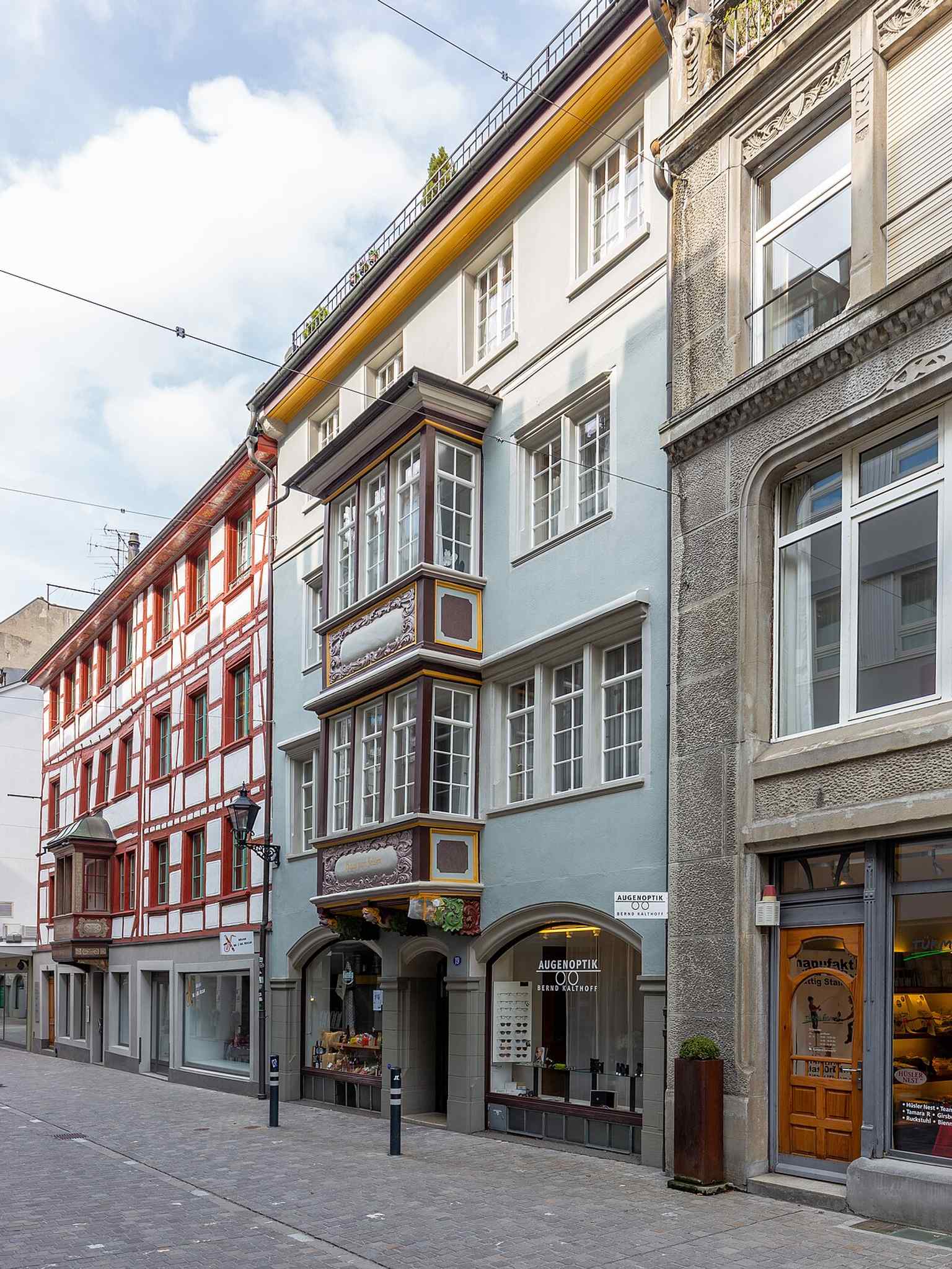 Historic townhouses with distinctive oriel windows on Webergasse, a reminder of the city’s preserved old town.