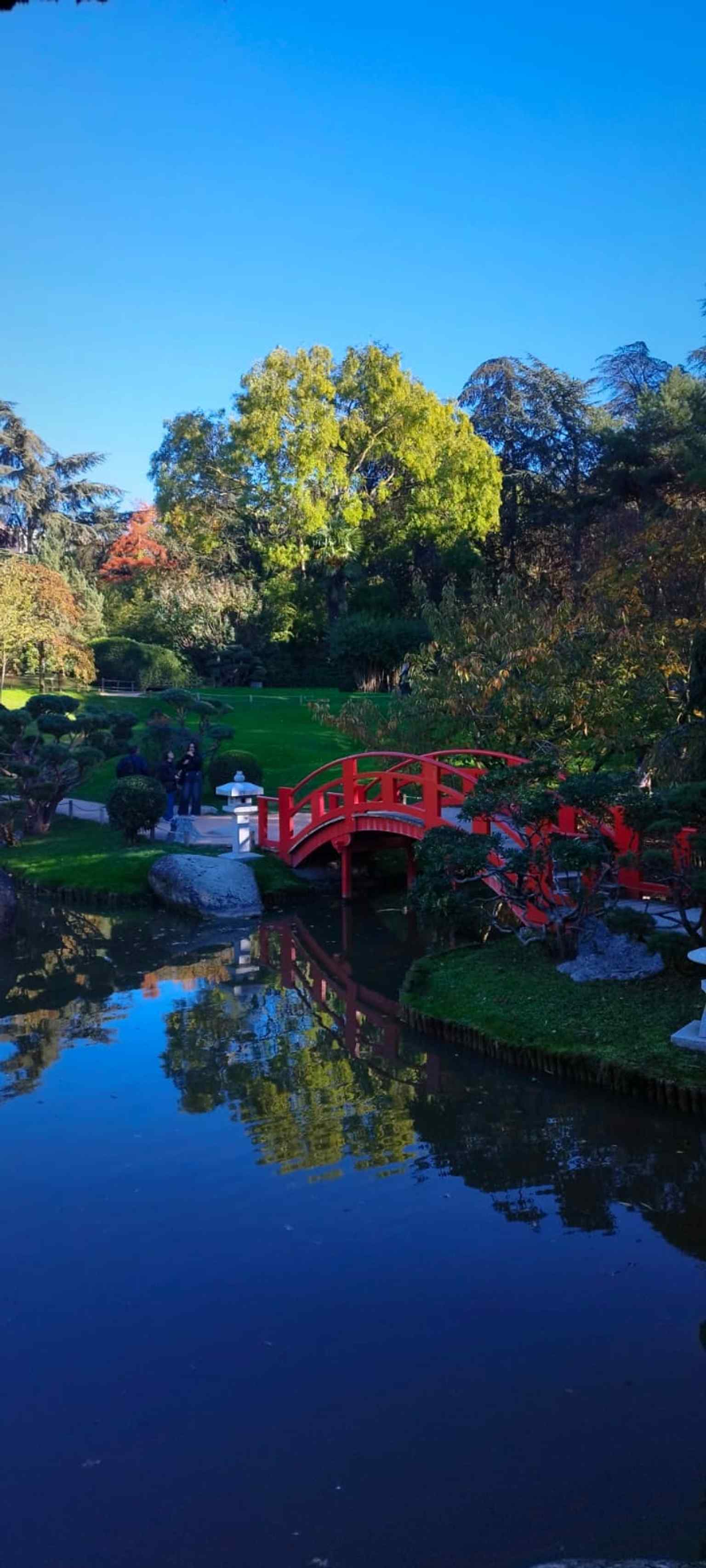 A close view of the red bridge, one of the garden’s most recognizable features and a strong visual symbol of its Kyoto-inspired design.