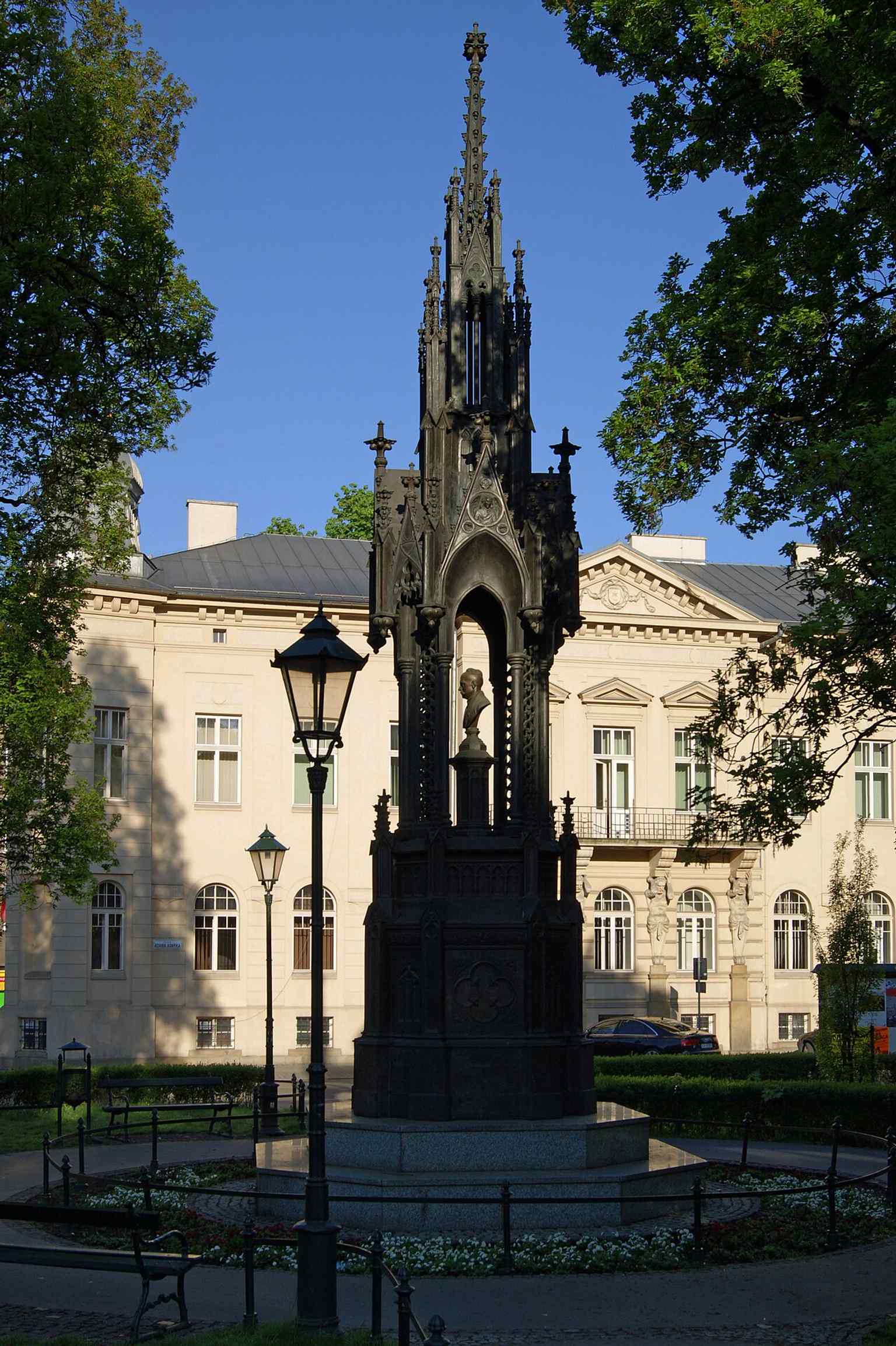 The monument from Garbarska Street, emphasizing the tall, chapel-like silhouette that was recreated from archival photos and the Powązki copy.