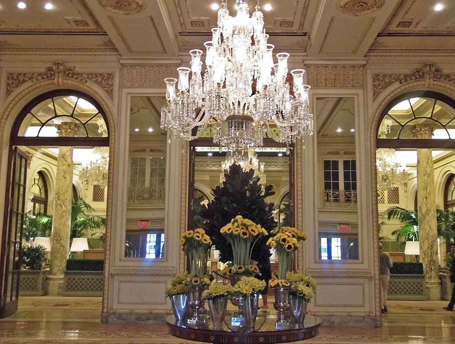 The main entrance lobby, one of the Plaza’s landmark interiors, designed to impress guests with marble, bronze, and a crystal chandelier.