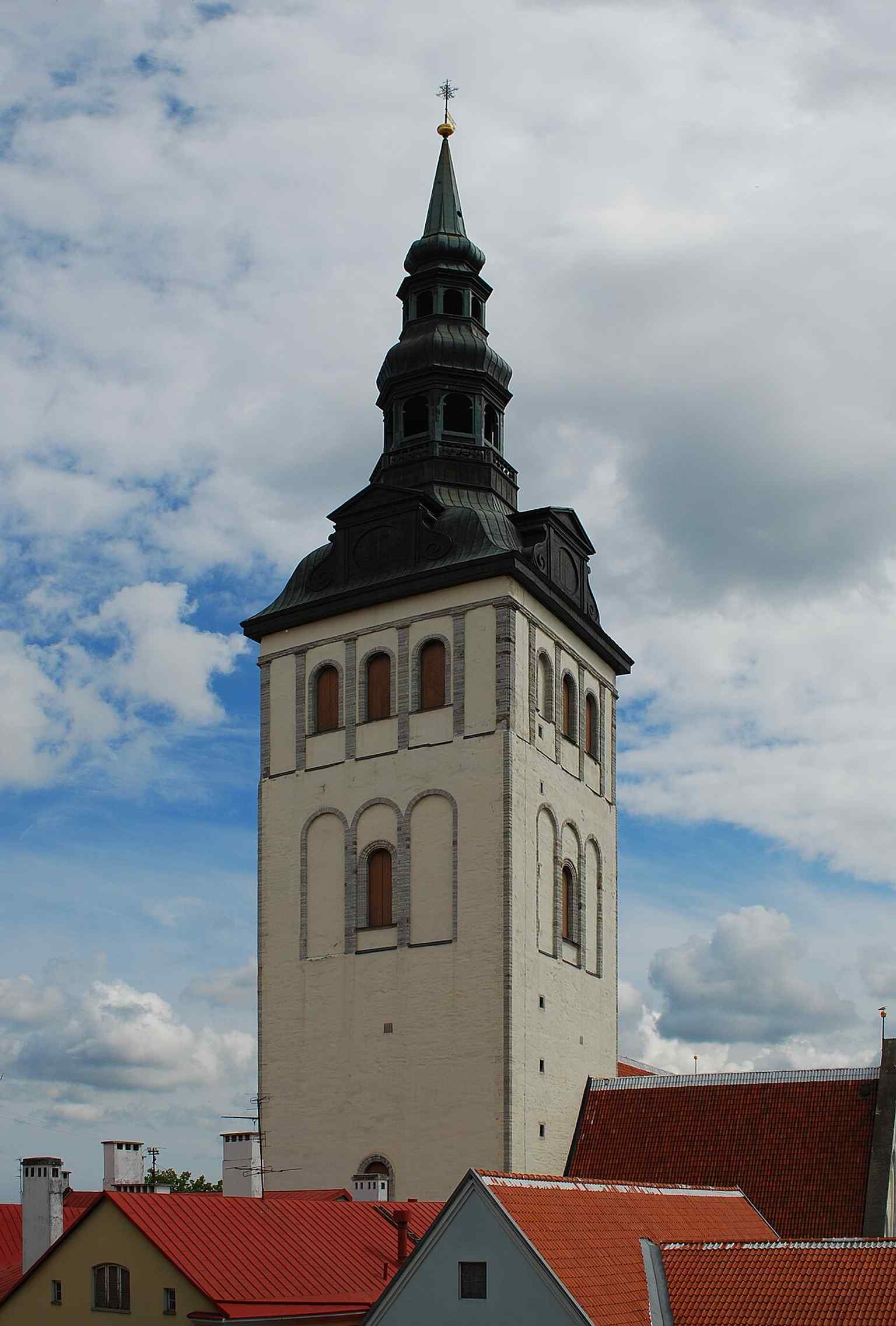 The church tower rising above Tallinn — a reminder of the 105-meter spire rebuilt after wartime destruction and later fire.