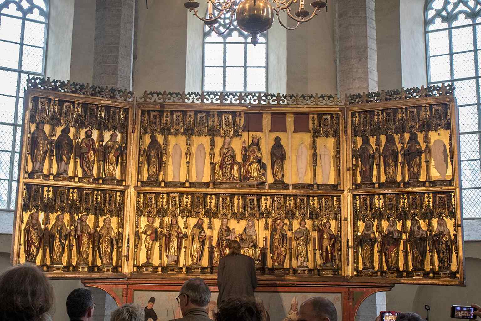 The open altarpiece reveals the rich painted and carved imagery that survived when much of the church’s other art was lost.