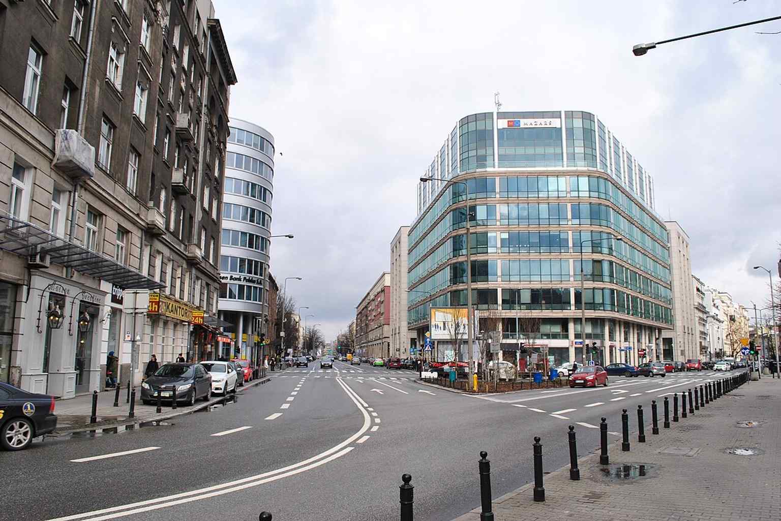 Krucza Street at the Mokotowska junction, with the Zaułek Piękna office building between them — the very corner where the street’s northern end and postwar office development meet.