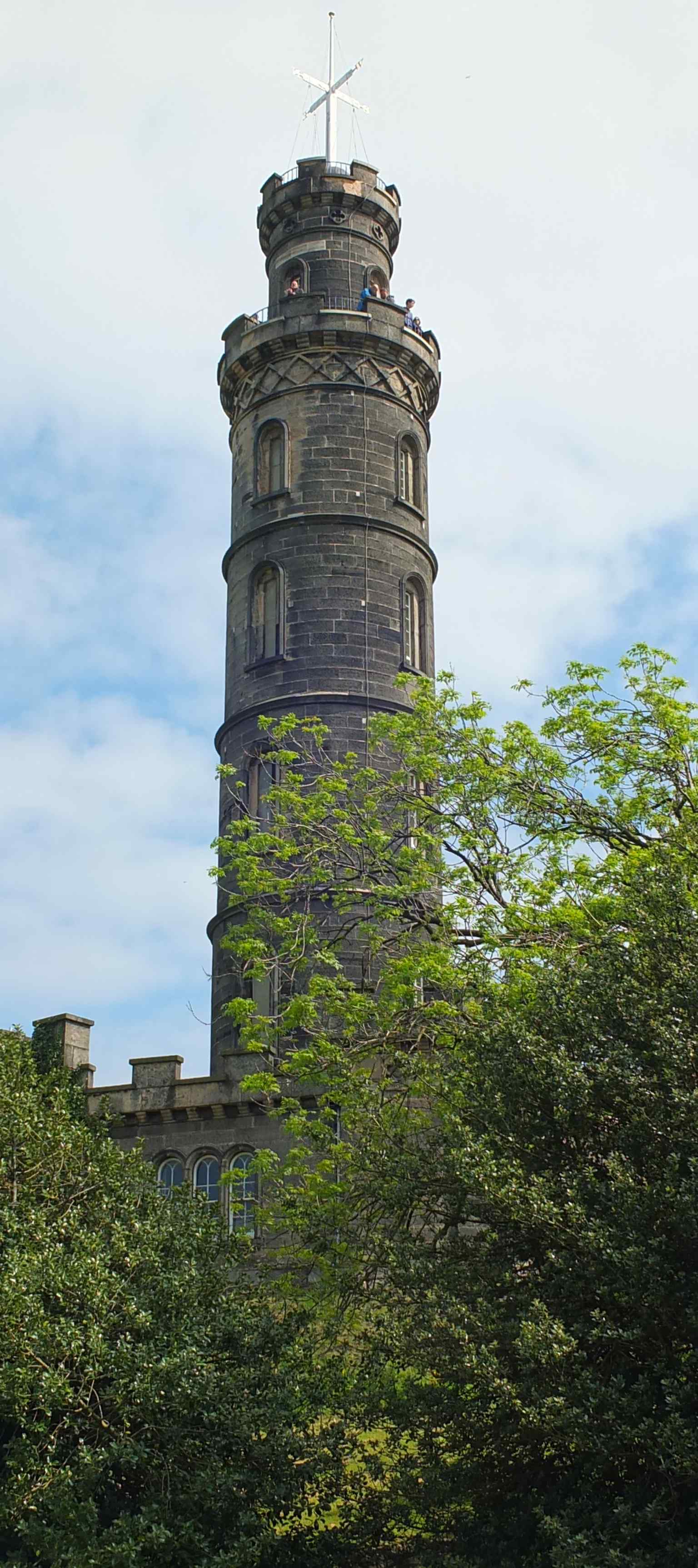 A close, vertical view of Nelson’s Monument rising above Calton Hill, ideal for emphasising the tower’s slender profile.