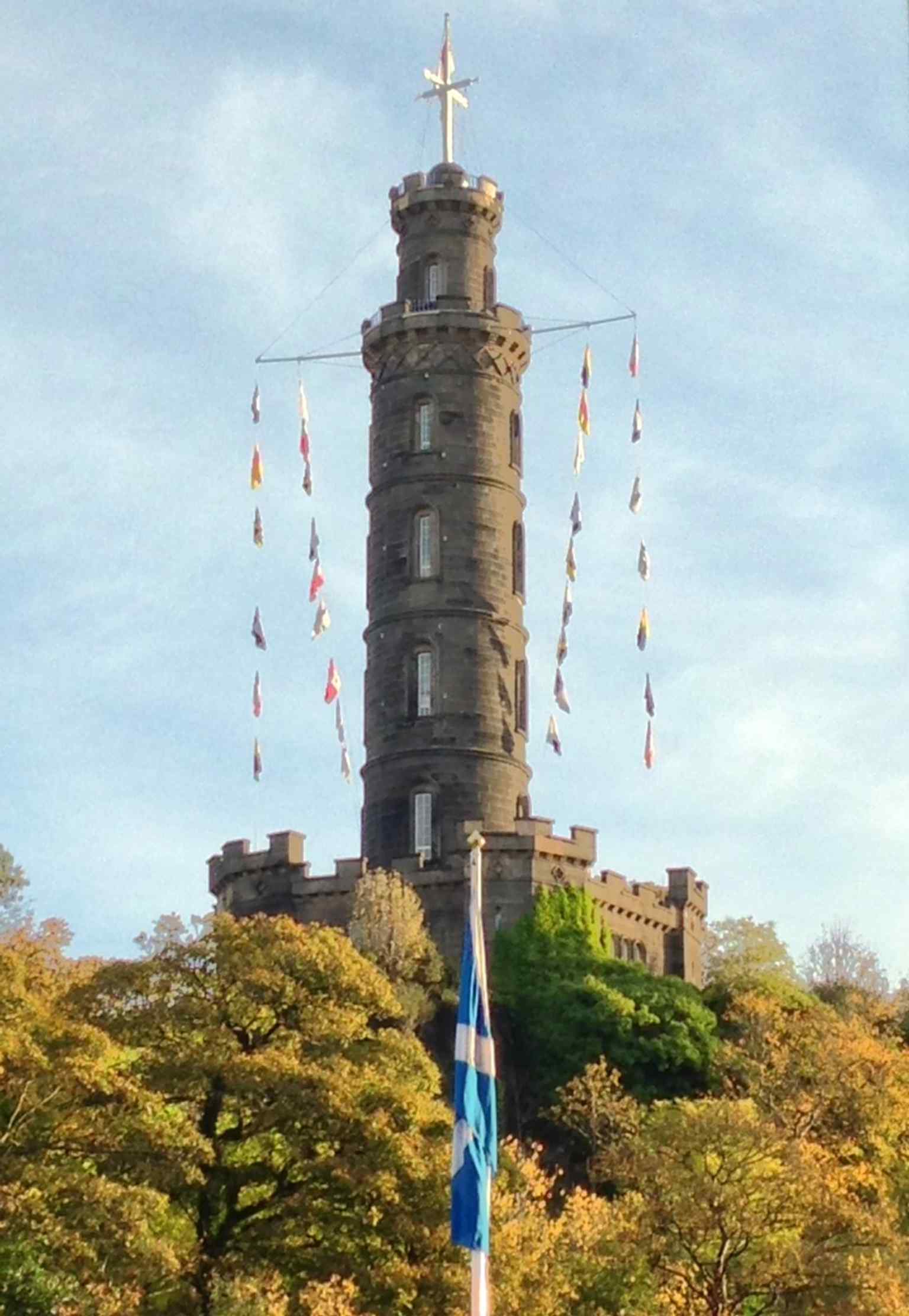 Flags flying from the monument on Trafalgar Day, echoing Nelson’s famous signal: ‘England expects that every man will do his duty.’