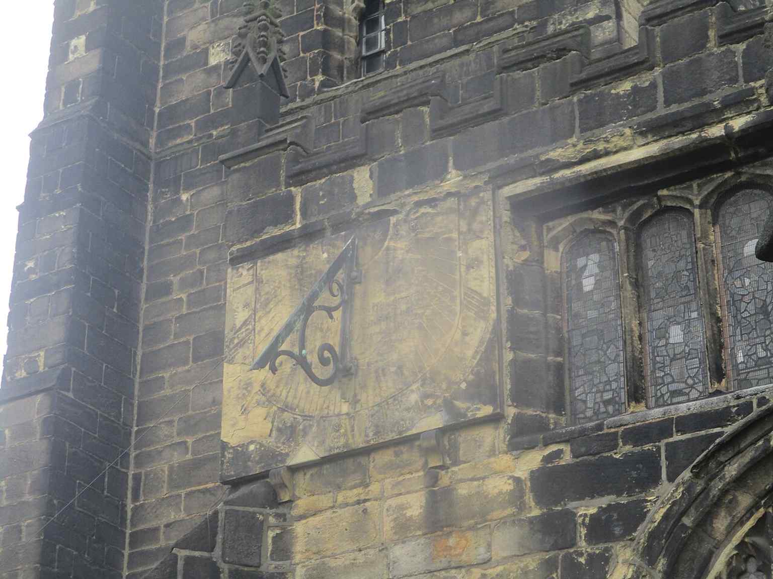 The church’s vertical sundial, a small but distinctive historic feature on the Minster exterior.