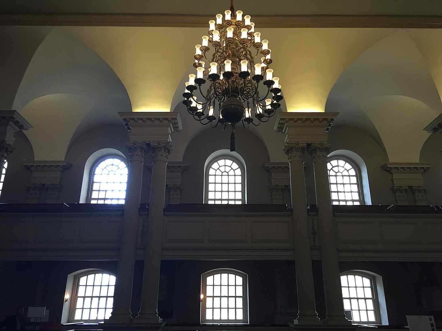 The chapel interior with its groin-vaulted ceiling and chandelier, reflecting the elegant colonial worship space that survived the Revolution.