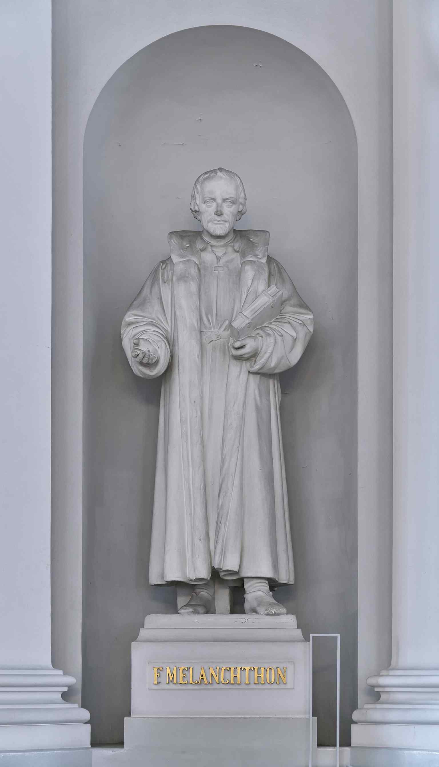 Martin Luther’s statue inside the cathedral, part of the trio of reformers that stand in the otherwise sparse church interior.