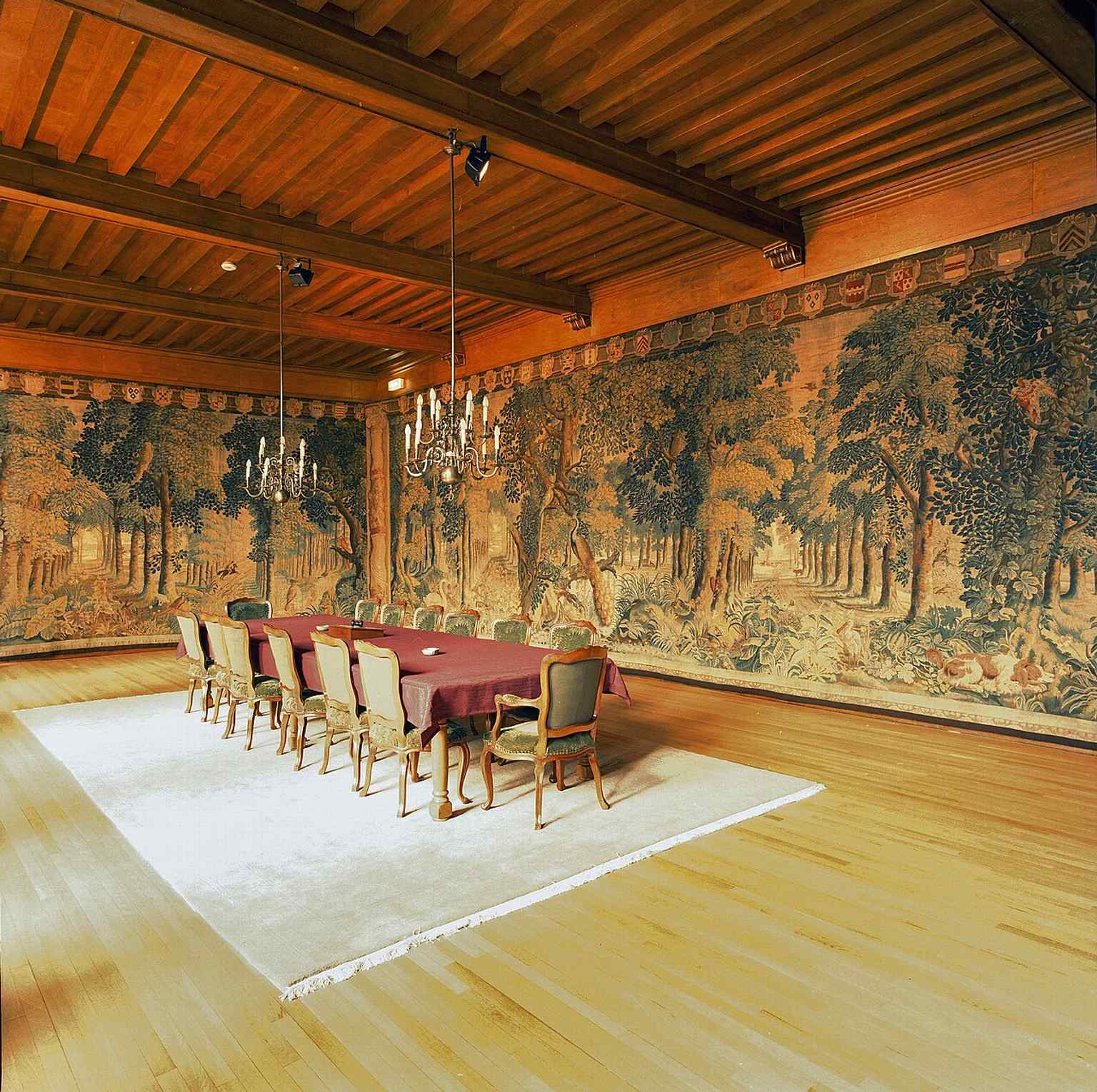 The elegant interior of the Regentenzaal, showcasing its elaborate tapestries and original beamed ceiling, where the regents have met since 1818.