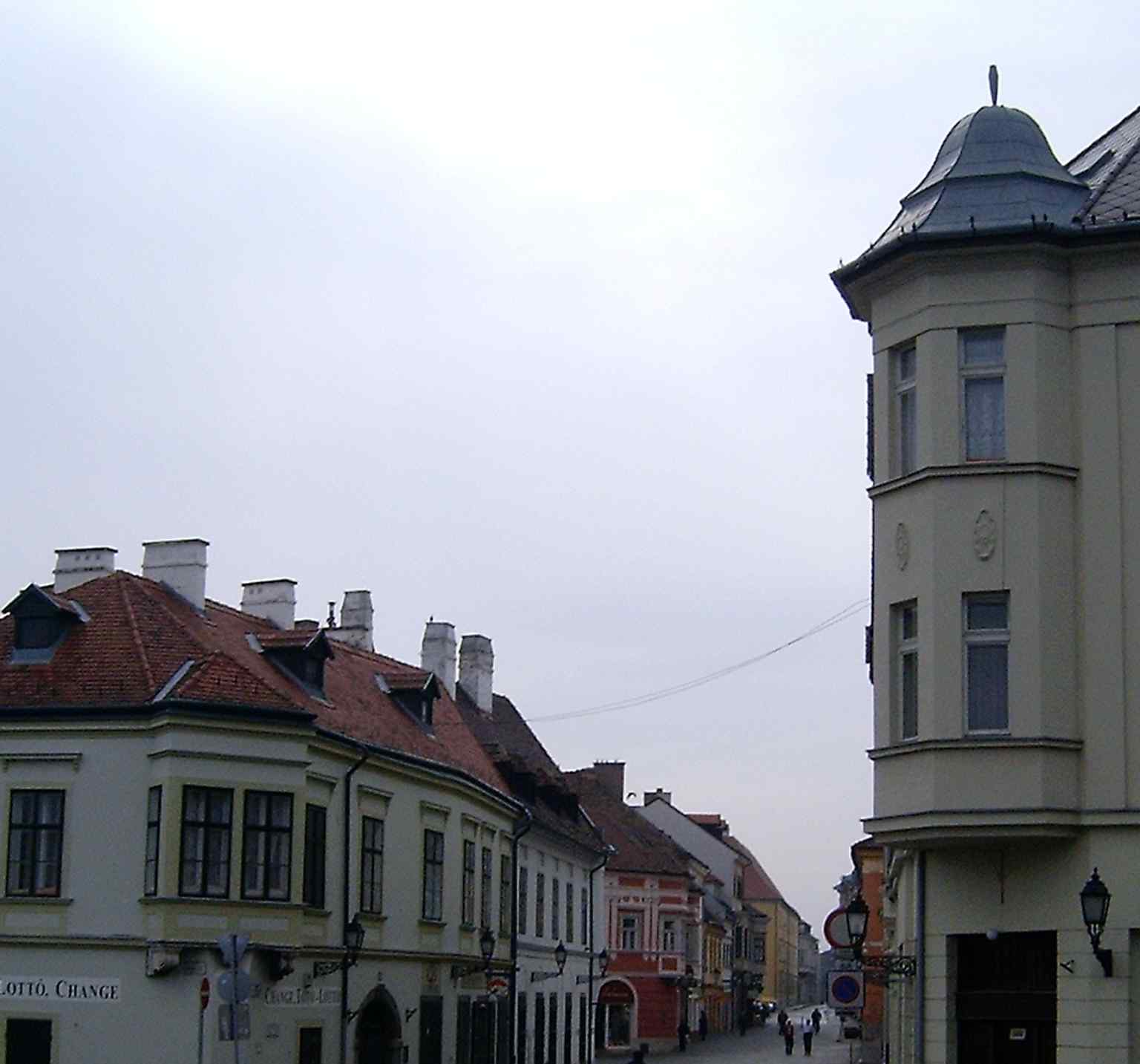 Looking from Dunakapu tér into Jedlik Ányos Street, the pedestrian route begins between the historic corner buildings described in the tour text.