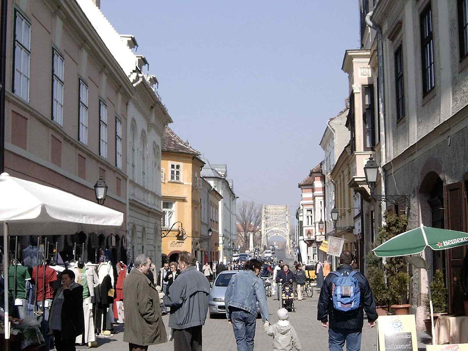 A view toward Jedlik Ányos Street from Széchenyi tér, showing the baroque streetscape that links Győr’s two central squares.