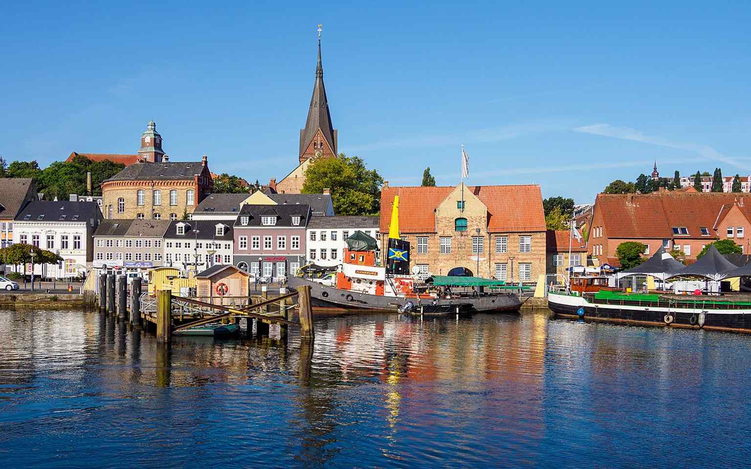 Kompagnietor rising behind Schiffbrücke, showing how the old harbor gate sits right in the port scene described in the tour text.