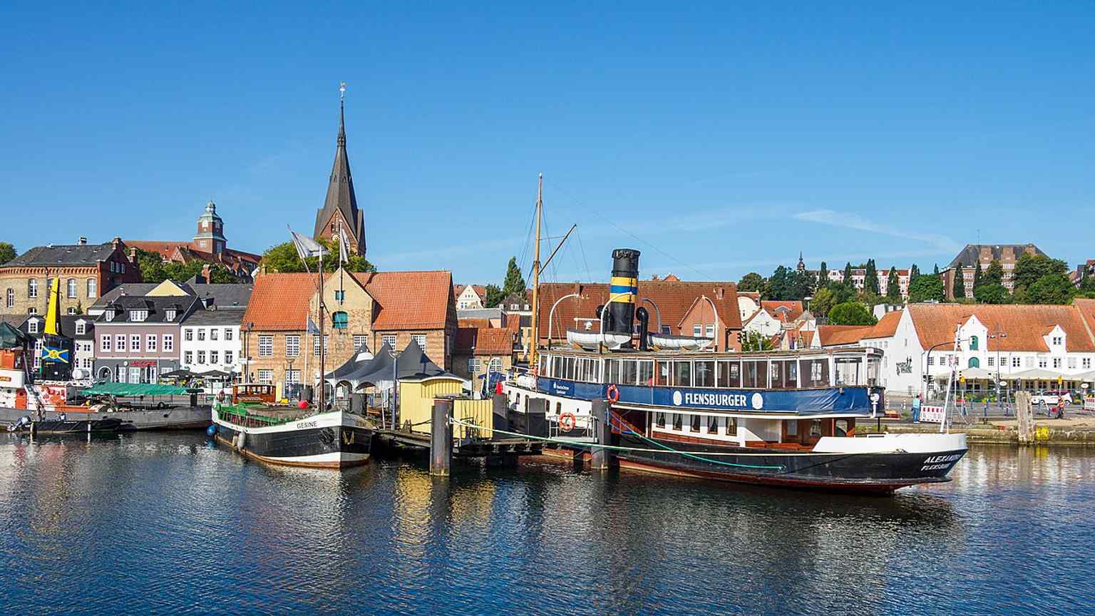 The harbor frontage with Kompagnietor in the background — a good context shot for the building’s setting at Flensburg’s ship bridge.