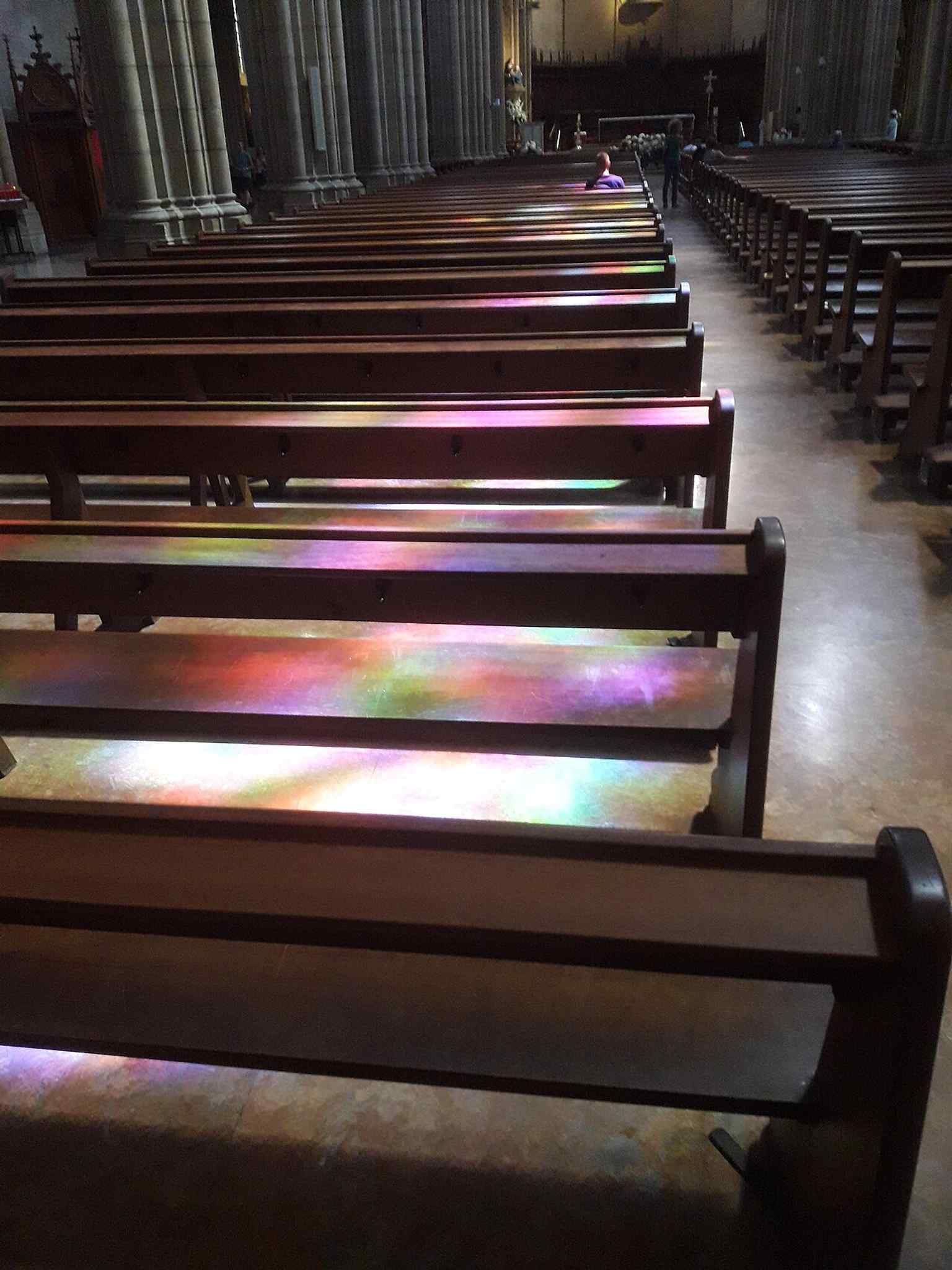 A broad interior shot that helps show the nave, vaulting, and the bright light filtered through the stained glass.