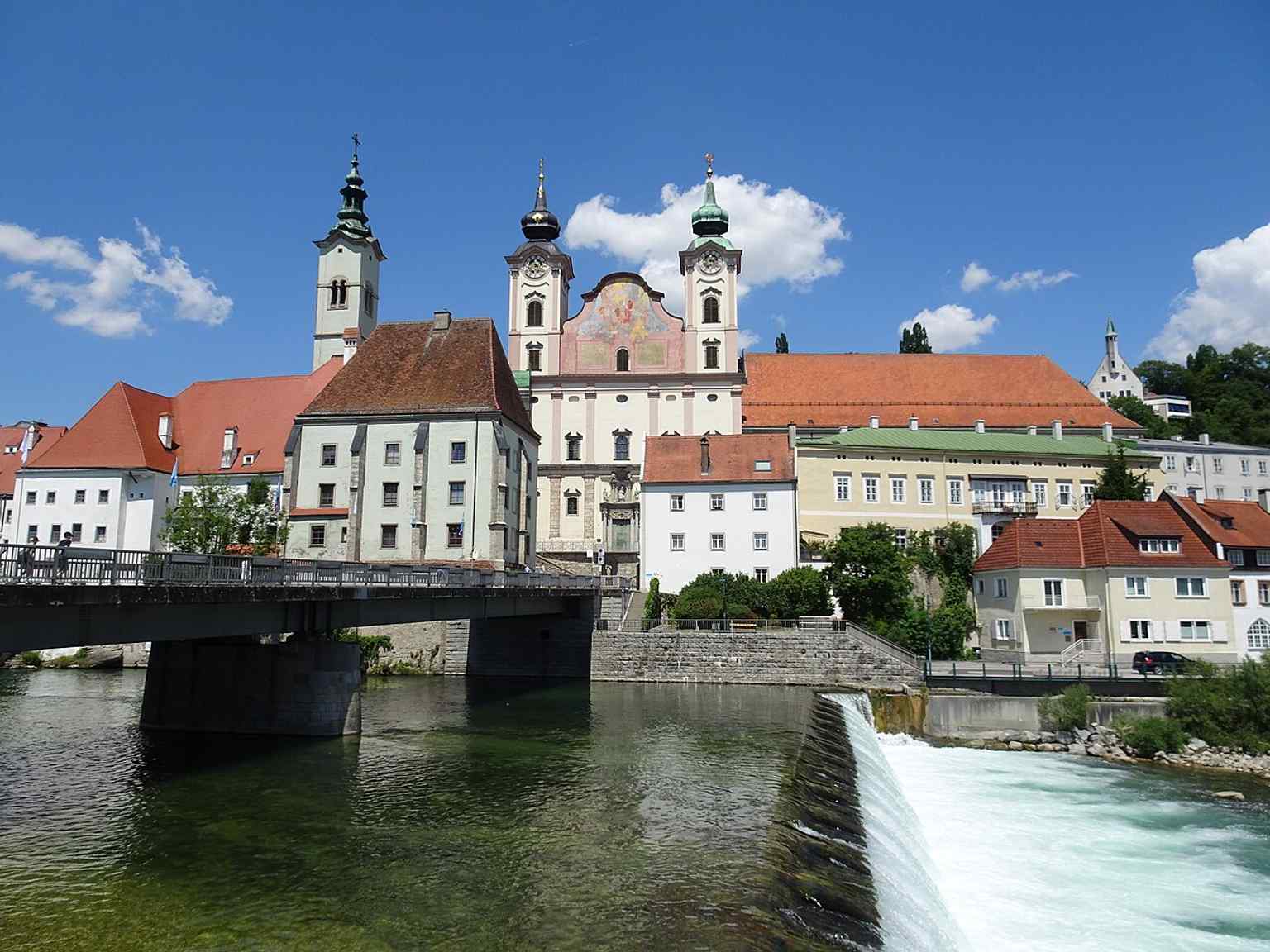 A wider confluence view placing St. Michael in the full river landscape of Steyr, where the church helps define the town’s silhouette.