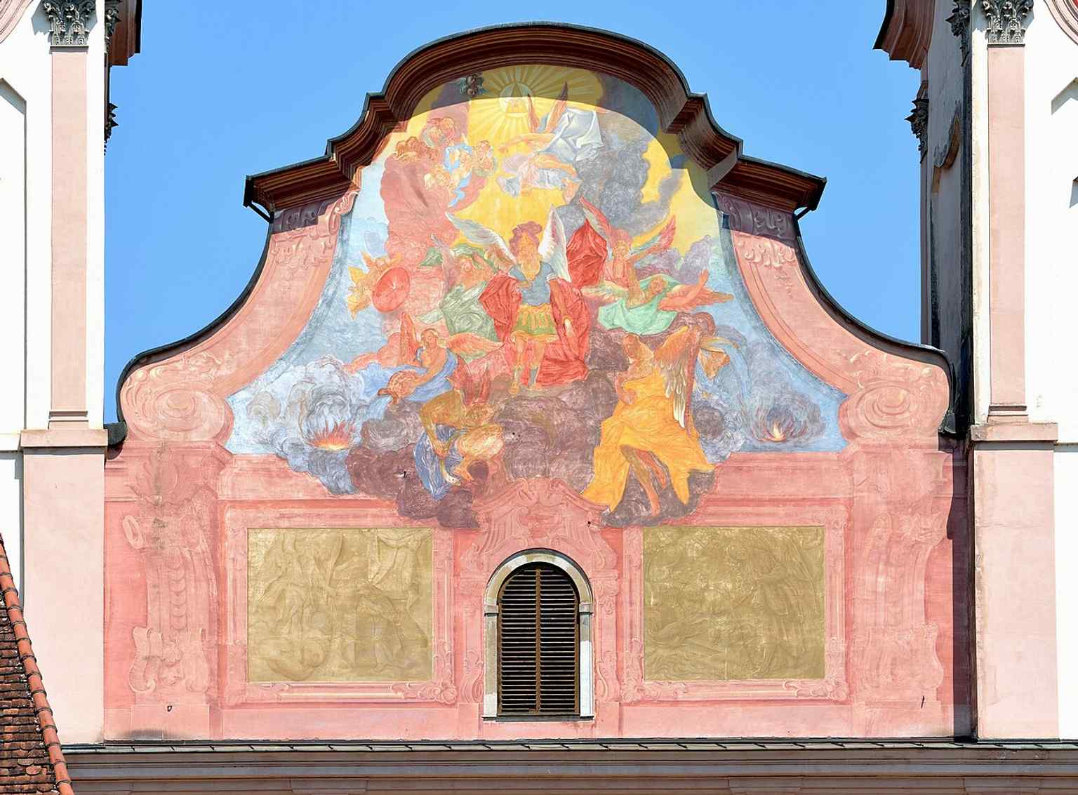 The pediment fresco by Franz Xaver Gürtler, including the dramatic angelic fall mentioned in the church’s history.