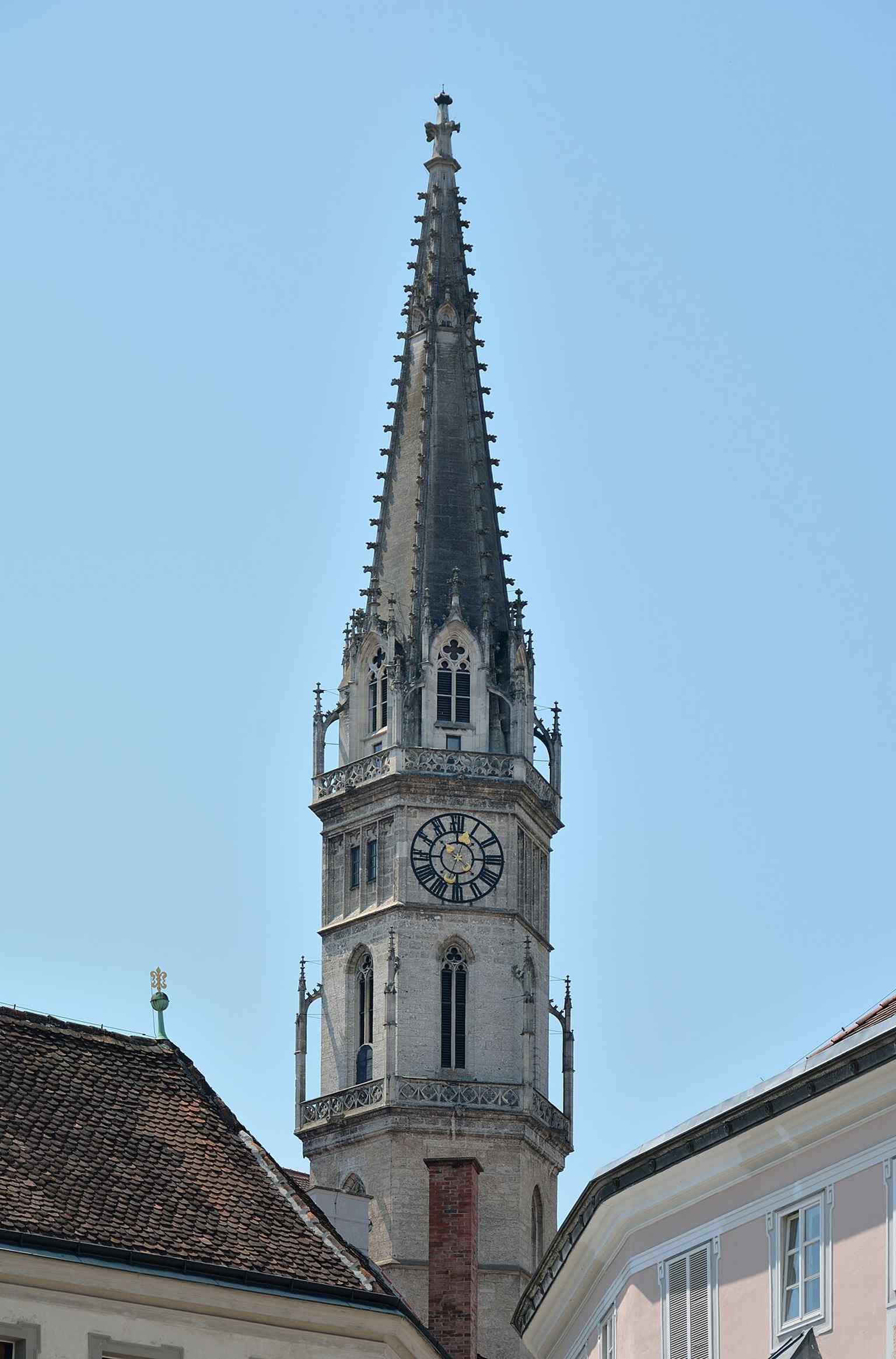 The tower view highlights the church’s powerful vertical landmark, including the neo-Gothic top added after the 1876 fire.