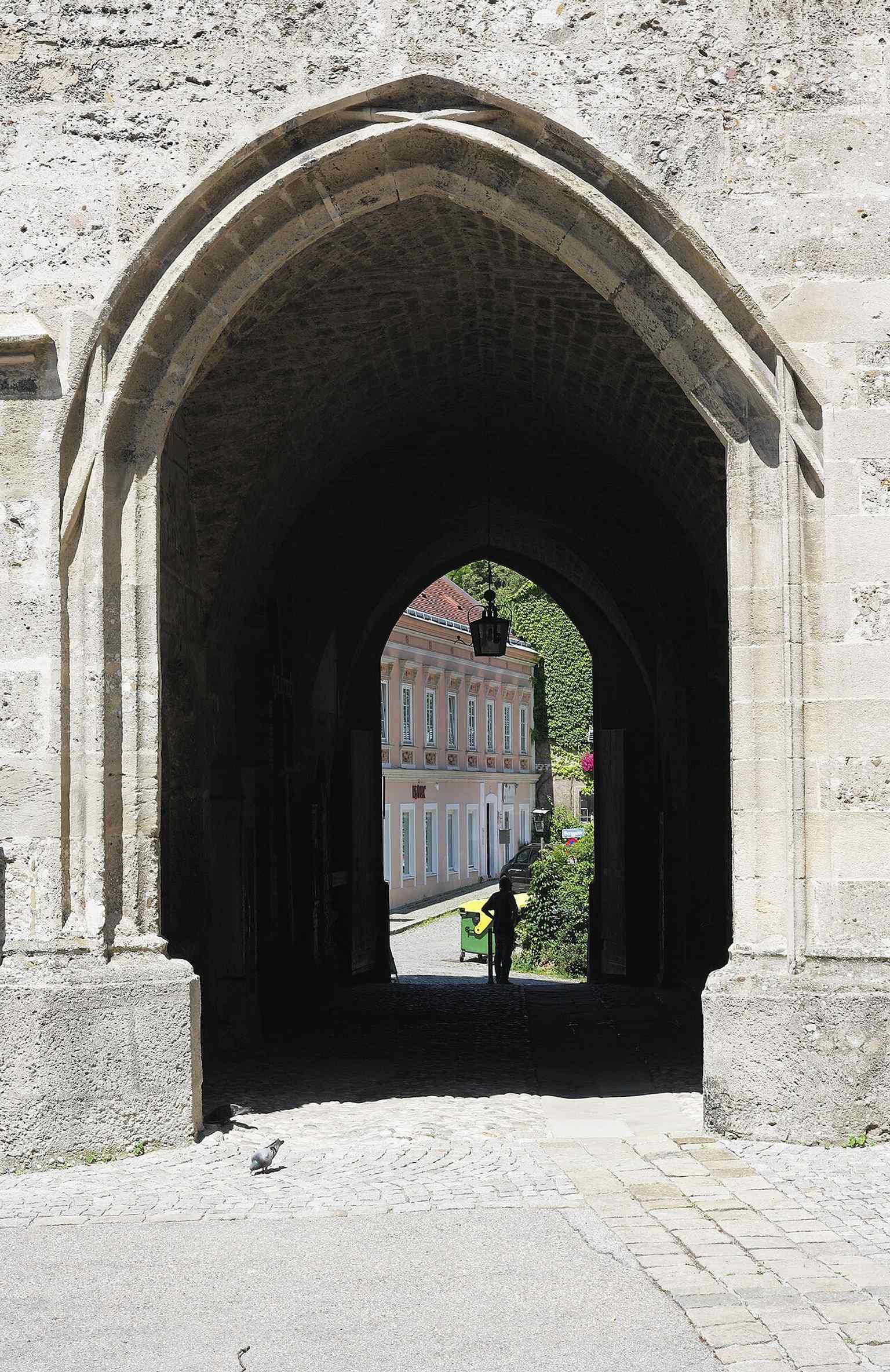 Looking through the west porch toward the old lane network, this image shows the 16th-century west entrance that was expanded during the Reformation era.
