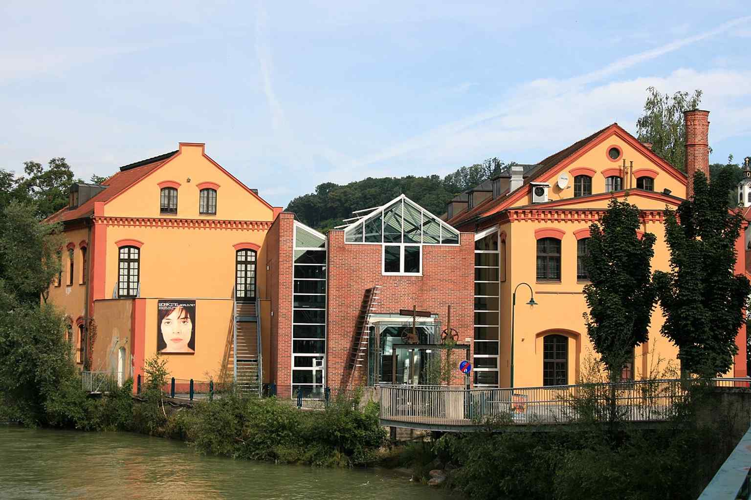 The renovated factory buildings of Museum Arbeitswelt on the Steyr River, fitting its mission to tell the story of work since industrialization.
