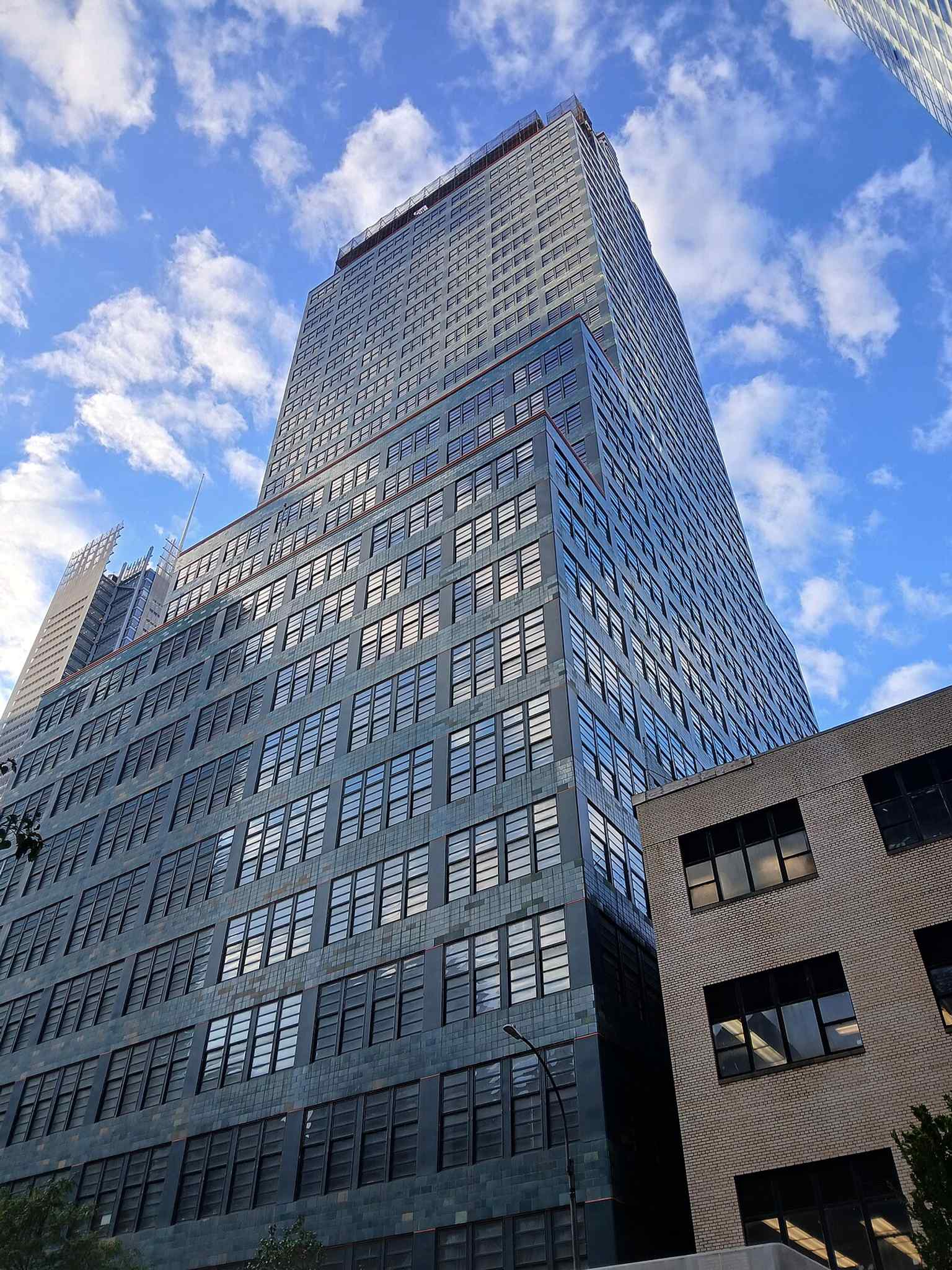 The 485-foot, 33-story skyscraper stands tall in Hell's Kitchen, noted as one of the tallest buildings in the neighborhood when completed, and intended to accommodate both commercial and industrial uses.