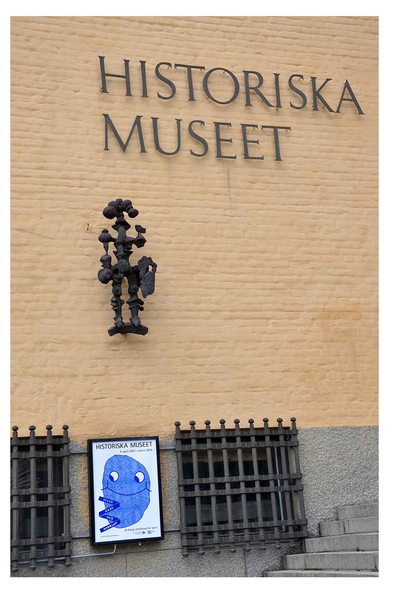 The museum façade with an exhibition poster, capturing how it uses current special exhibitions alongside its permanent displays.