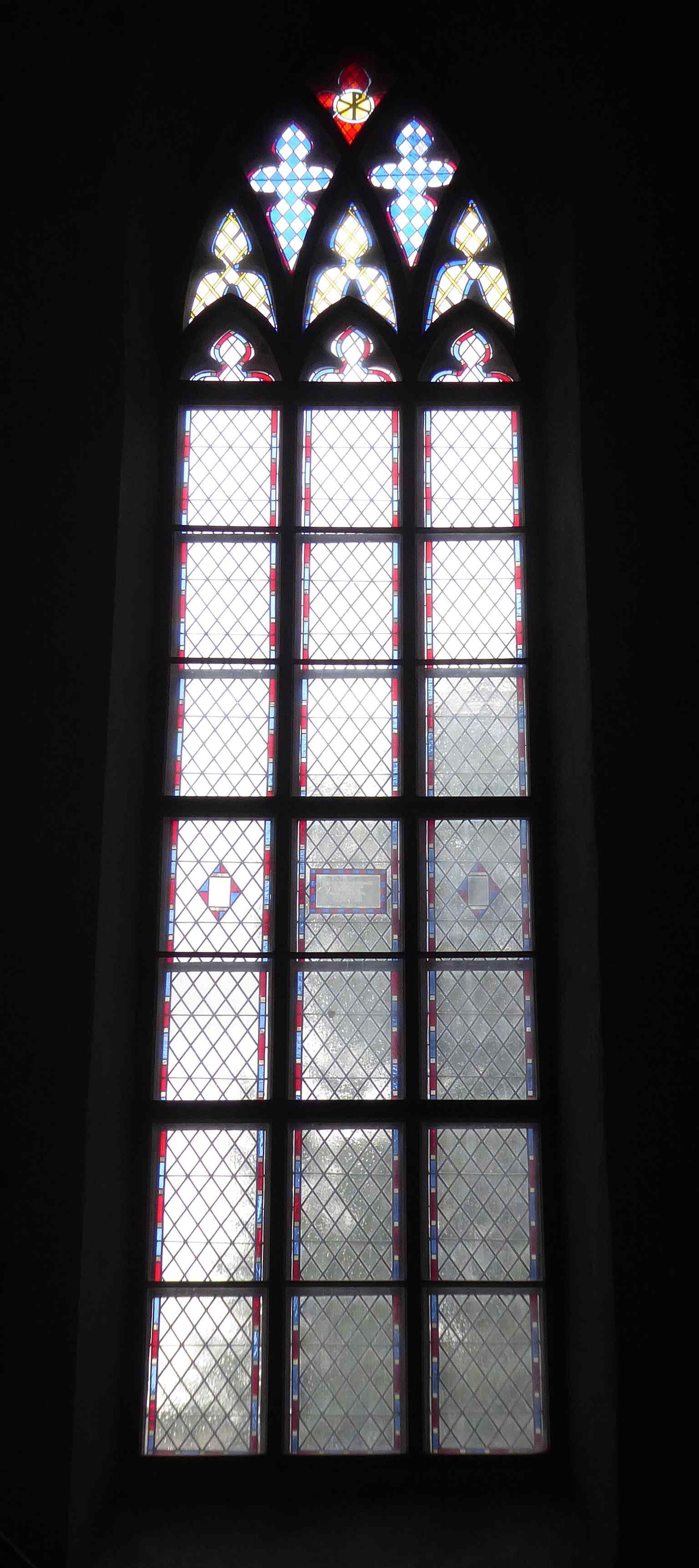 A stained-glass window inside the cathedral, part of the later interior decoration added to the medieval church.