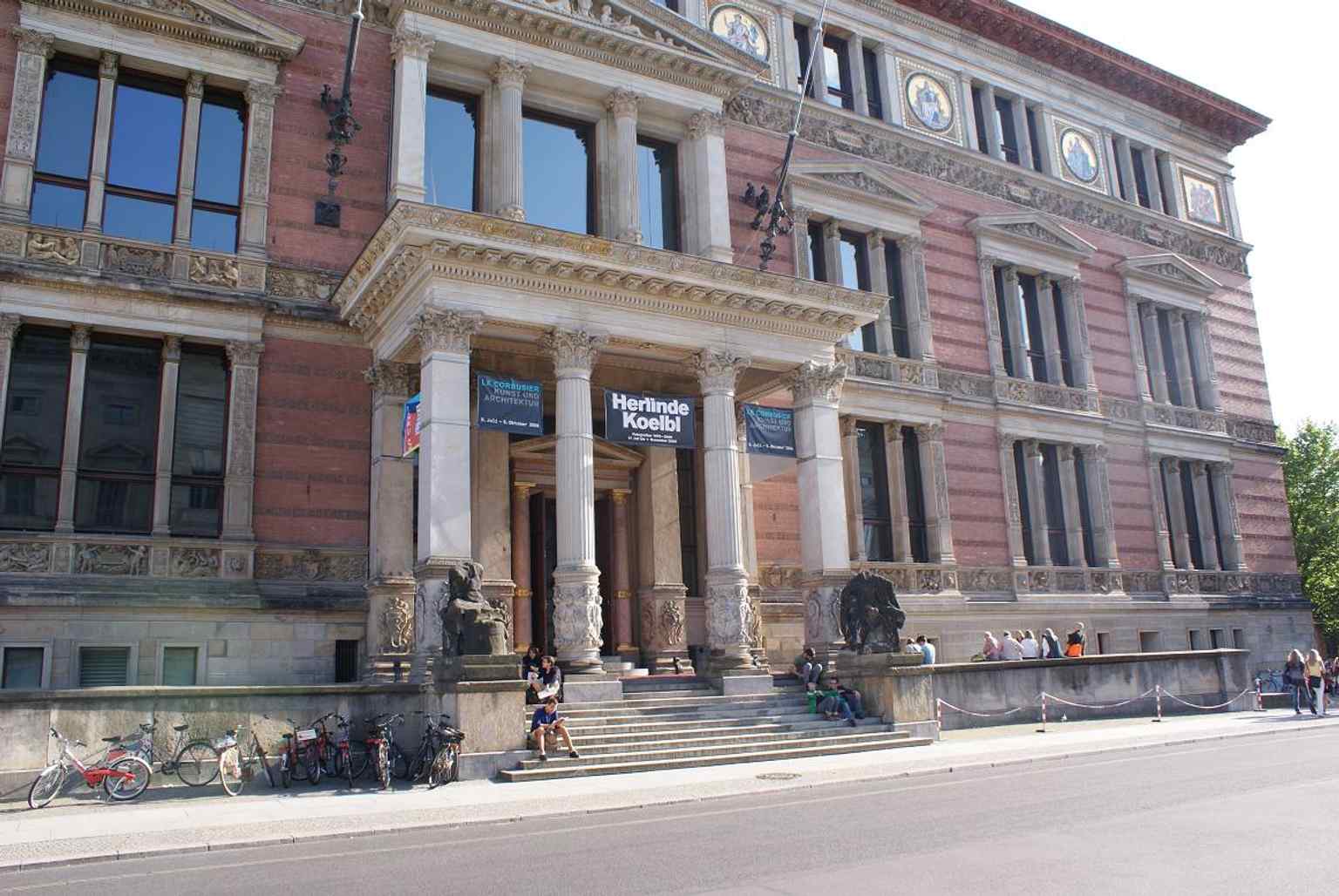 A wider streetscape with the neighboring parliament building, placing Gropius Bau in its dense political and cultural setting.