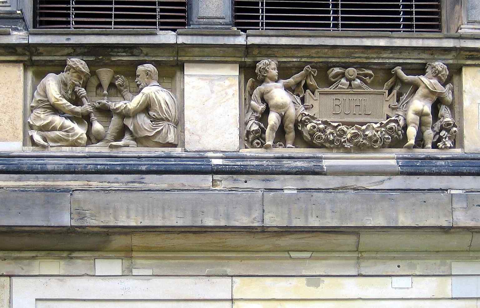 Decorative façade reliefs with putti, a reminder of the ornate sculptural program that survived and was reconstructed after wartime damage.