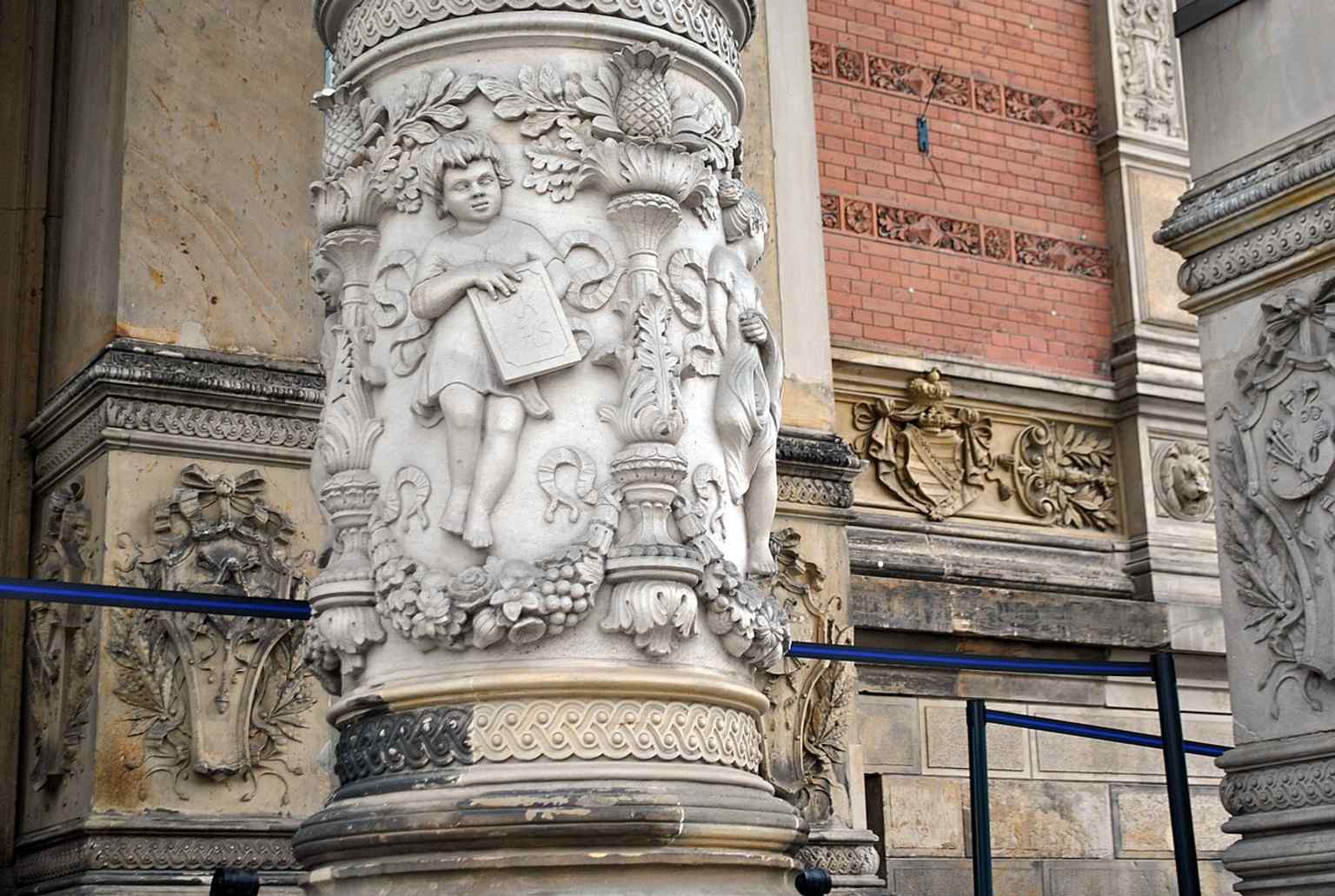 A close detail of the historic ornamentation, showing the richly decorated skin of the neo-Renaissance façade.
