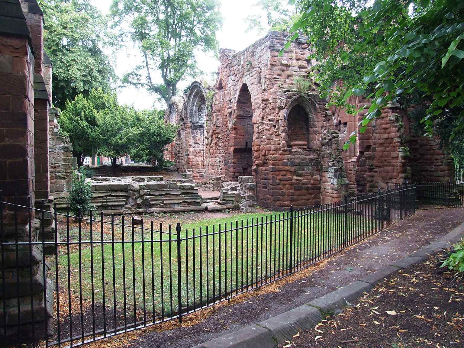 Looking toward the ruined east end, this image shows how much of the larger medieval church was lost after the Dissolution.
