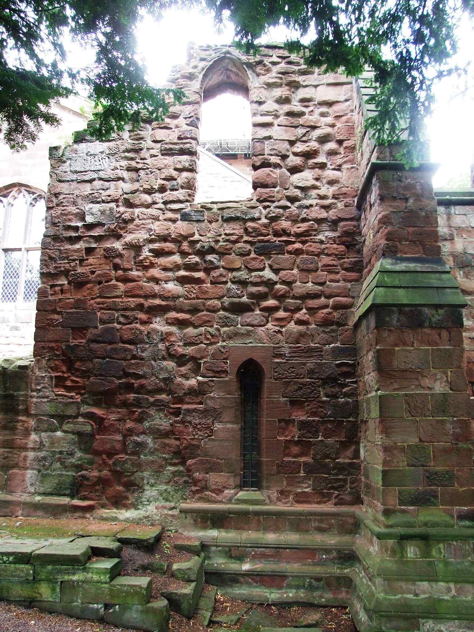 The south side beside the remains of the former east end, a striking reminder that the present parish church sits inside a much larger ruined shell.