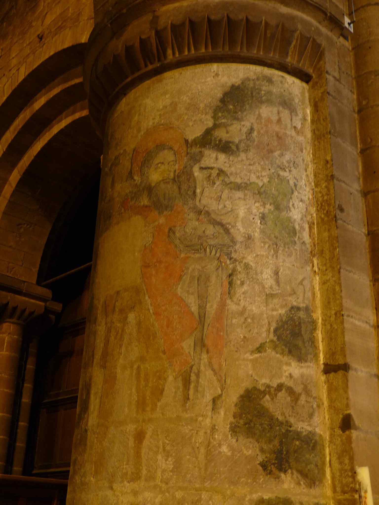 A painted medieval pillar in the nave, showing that much of St John’s interior preserves Norman and later medieval work despite Victorian restoration.