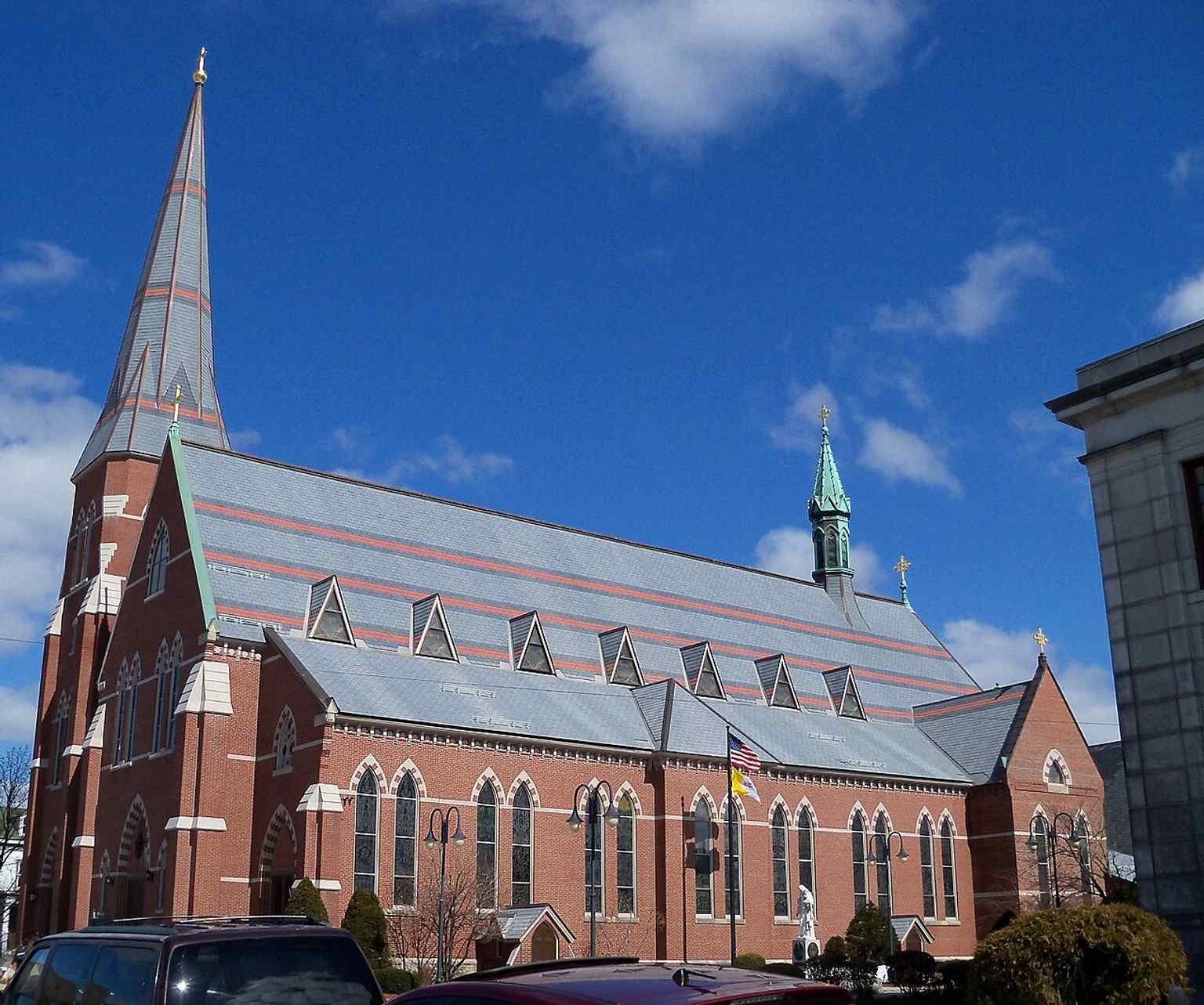 A clear exterior view showing the cathedral as it stands today on Lowell Street, serving the Roman Catholic Diocese of Manchester.