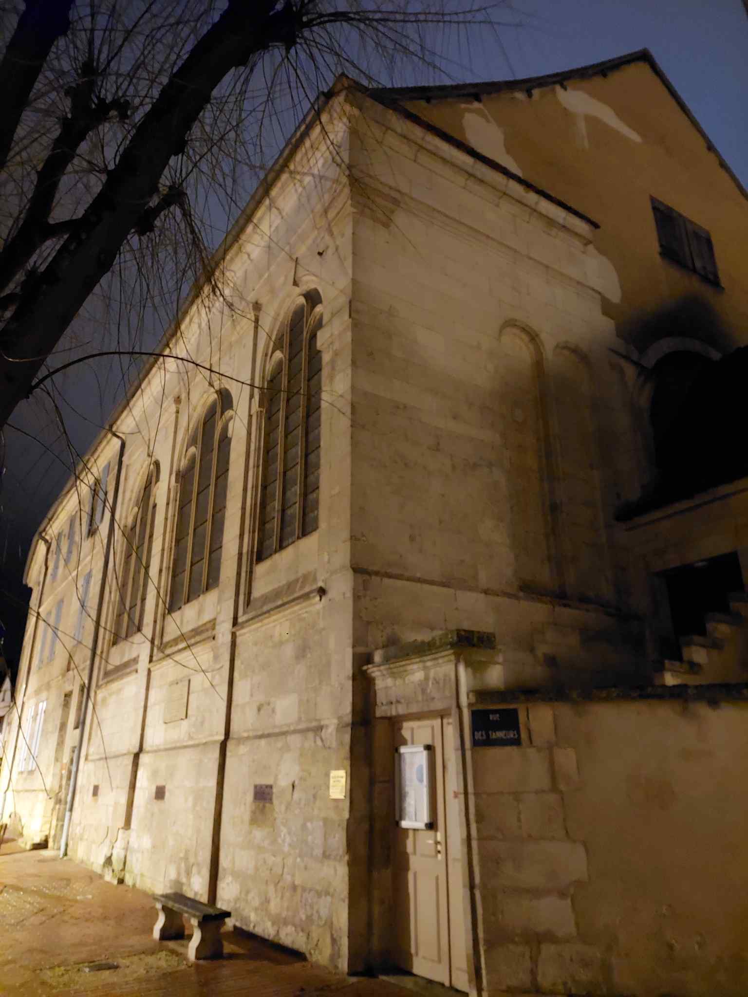 This view of the former Église Saint-Pèlerin highlights its unique transformation; in 1866, it became the official Protestant worship center, ironically 300 years after Catholic authorities barricaded a nearby city gate to defend against Protestant raids.