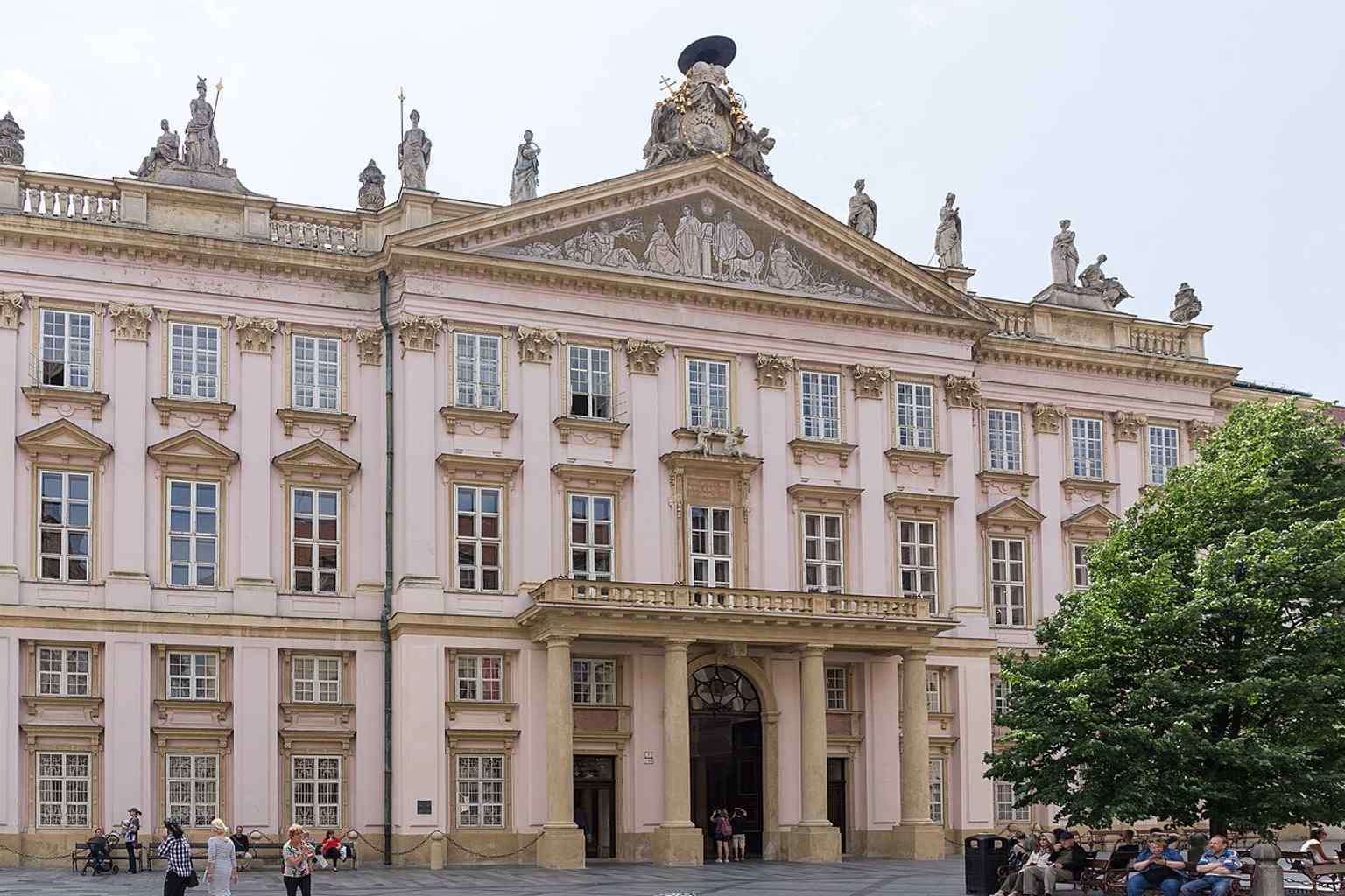 A crisp modern view of the palace’s main façade on Primatial Square, showing the grand classical front that fills nearly the whole south side of the square.