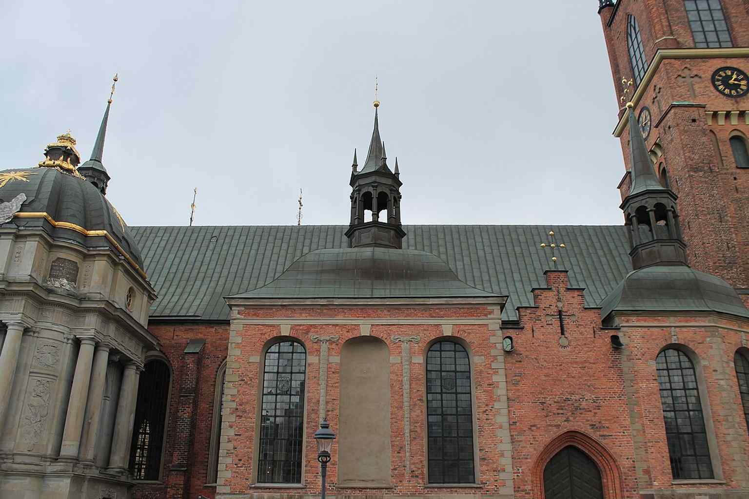 A closer architectural view of the church façade, ideal for the brick detailing and vertical Gothic character described in the script.